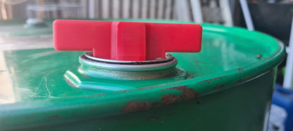 Close-up of the Agimate drum bung key opener inserted into a drum bung.