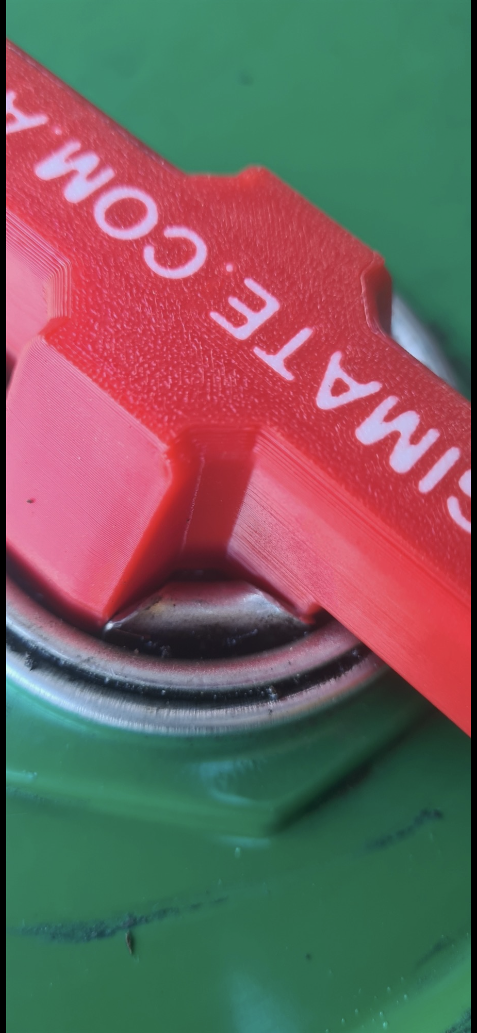Detail view of the Agimate drum bung key opener showing the fitted tip inside the bung.