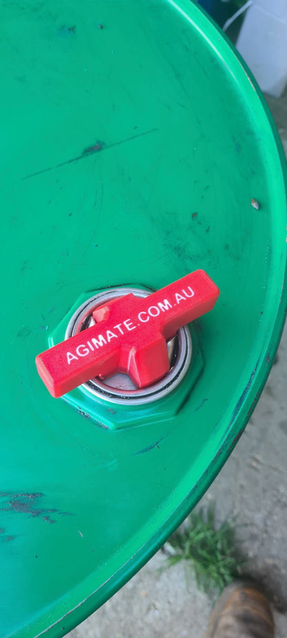 Agimate drum bung key opener fitted into the bung of a green steel drum.
