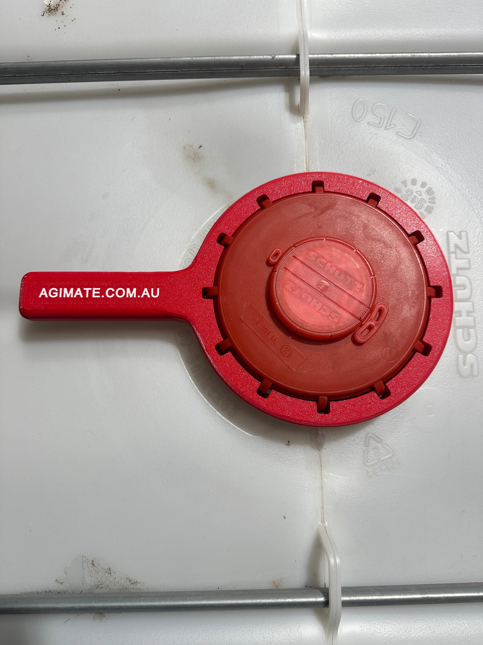 Agimate IBC lid cap spanner fitted over a Schutz IBC tote cap, viewed from above.